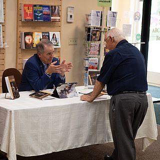 John McVay talks to someone at his book signing